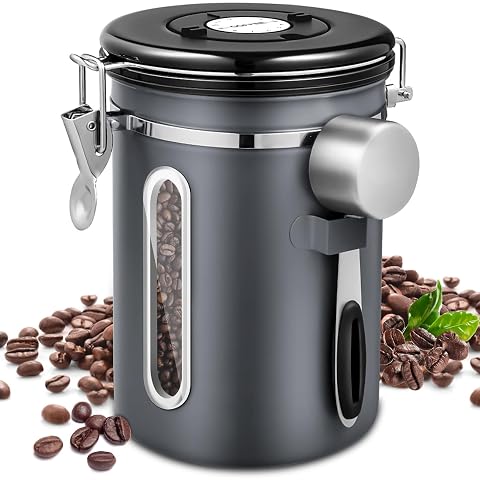 Boîte à café grise en acier inoxydable avec cadran dateur, valve et cuillère de mesure.