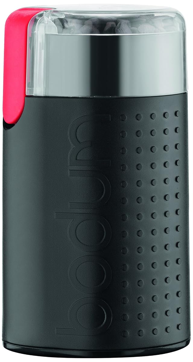 Moulin à café électrique Bodum Bistro noir avec couvercle transparent sur un plan de travail en bois
